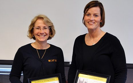 Sharyn Freyermuth and Laura Carroz holding awards
