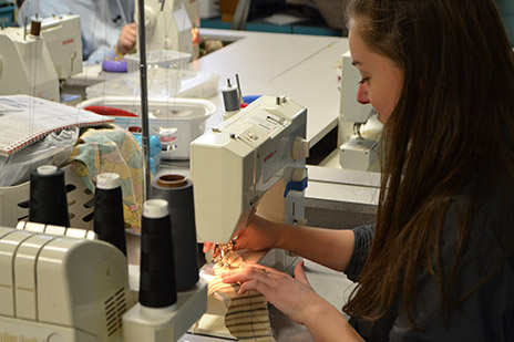 Caitlin Allen working on a costume.