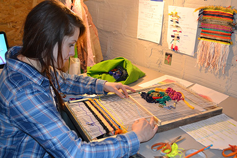 Madalynn Olmsted working on her artwork.