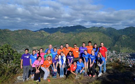 Group of volunteers in front of a mountain vista