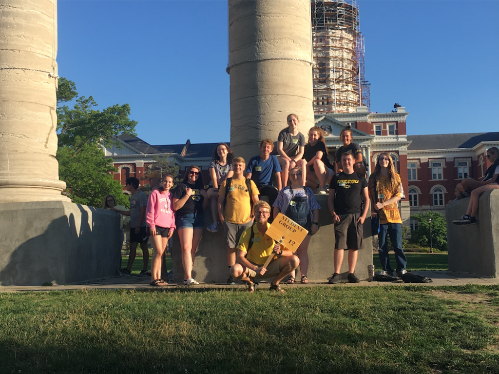 A student group poses in front of the Columns on the University of Missouri's campus.