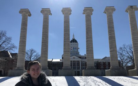 Jillian Marino stands in front of the snowy Columns at the University of Missouri.