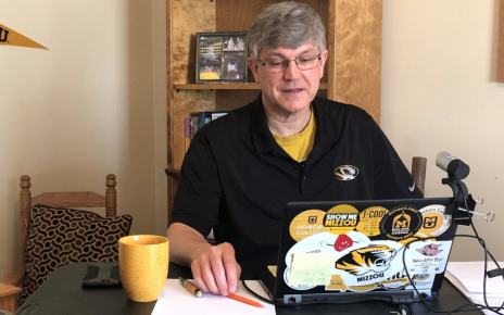 Jim Spain works on his laptop computer at home.