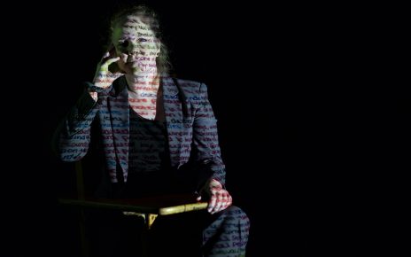 Portrait of Yve Solbrekken with text projected across her face
