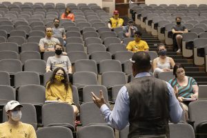 Students sit socially distanced in an MU lecture hall