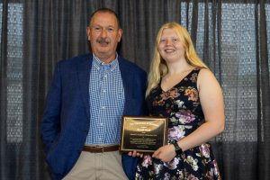 Randi Noel holding her award plaque