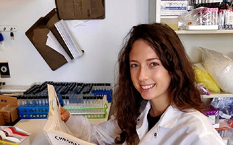Jillian Otto reads Chromatography book in lab