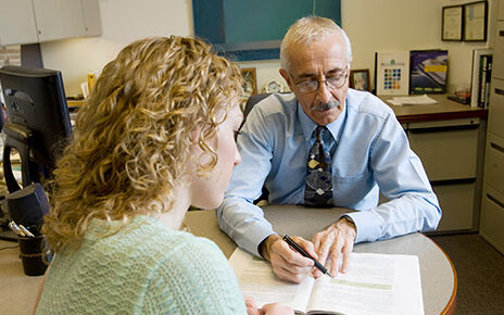 Loren Nikolai works with a student.